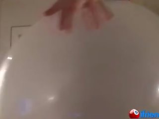 Sweetheart in black blows up giant balloon